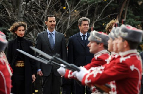 Syrian's first couple, left, and Bulgarian President Georgi Parvanov review an honor guard on November 9, 2010, during an official welcoming ceremony in Sofia, Bulgaria. It is the first visit to Bulgaria by a Syrian leader in 24 years. 