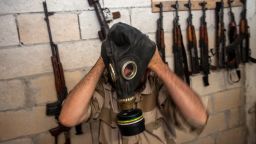 A Syrian rebel tries on a gas mask seized from a Syrian army factory in the northwestern province of Idlib on July 18, 2013. Western countries say they have handed over evidence to the UN that Bashar al-Assad's forces have used chemical arms in the two-year conflict. More than 100,000 people have died in the conflict, which morphed from a popular movement for change into an insurgency after the regime unleashed a brutal crackdown on dissent. AFP PHOTO/DANIEL LEAL-OLIVAS (Photo credit should read DANIEL LEAL-OLIVAS/AFP/Getty Images)