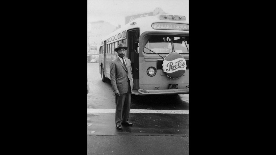 King stands in front of a bus at the end of the Montgomery bus boycott in Montgomery, Alabama, on December 26, 1956. 