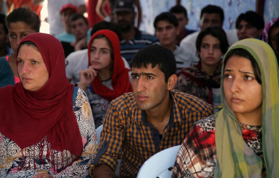 Syrian refugees listen to safety instructions at the Quru Gusik refugee camp in August 2013.