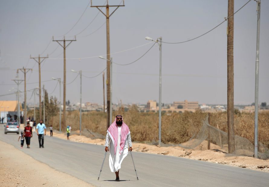 Syrian refugees walk at the Zaatari refugee camp in July 2013.