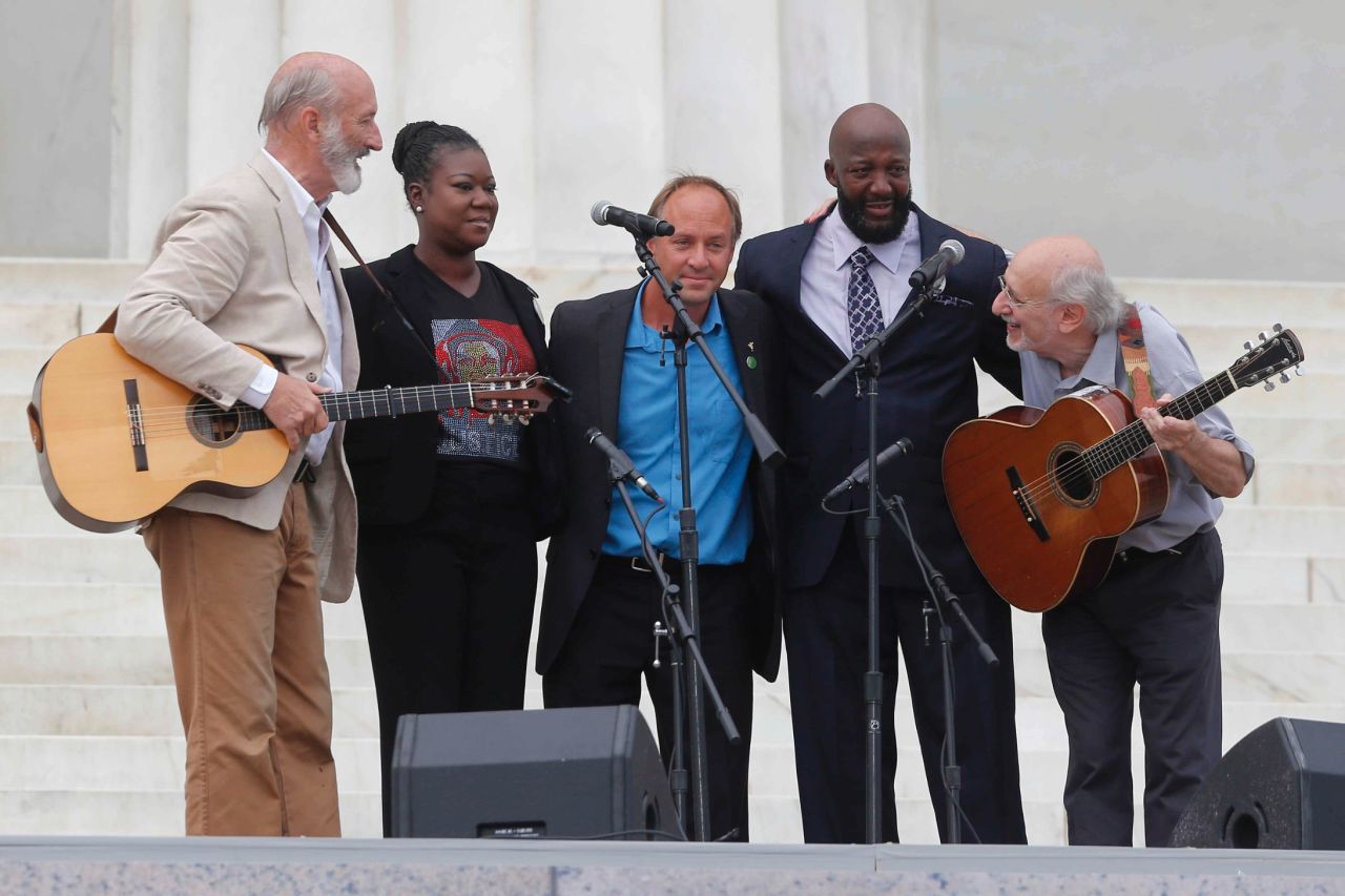 Peter Yarrow, left, and Paul Stookey, right, of the folk trio Peter, Paul and Mary, stand with Trayvon Martin's parents, Sybrina Fulton and Tracy Martin, at Wednesday's celebration.