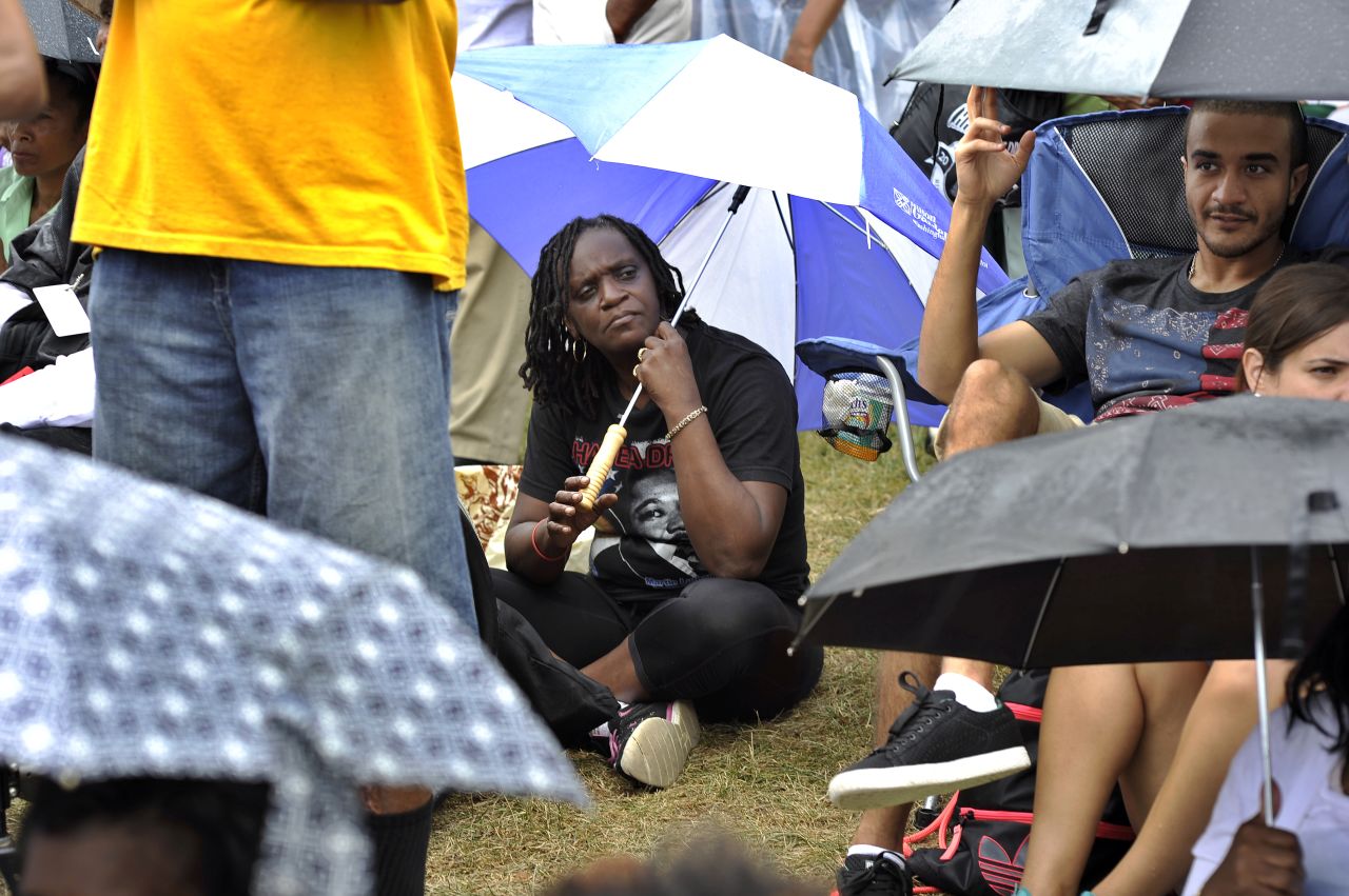 People brave light rain as they participate in the march's anniversary.