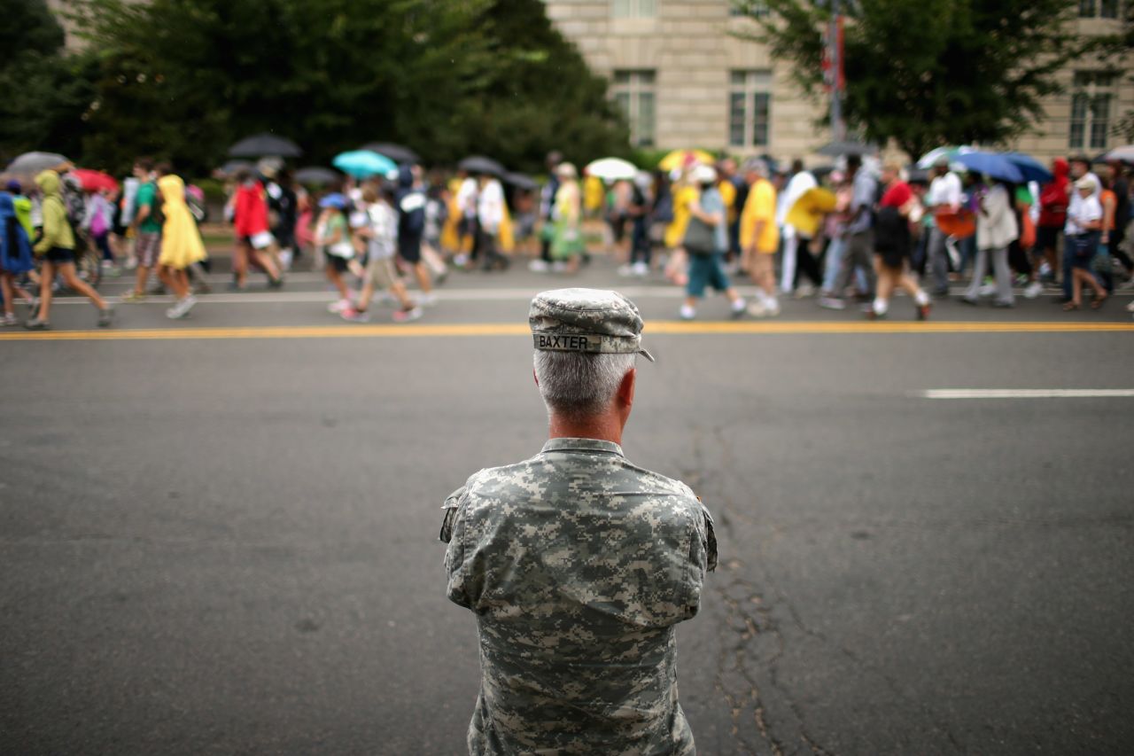A member of the U.S. Army National Guard watches as thousands of people march from Capitol Hill to the Lincoln Memorial in Washington on August 28.