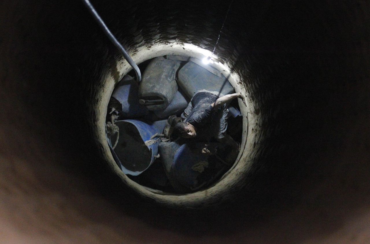 AUGUST 28 - GAZA, PALESTINIAN TERRITORIES: A Palestinian tunnel worker peers inside a smuggling tunnel dug beneath the Gaza-Egypt border in southern Gaza on August 27. <a href="http://cnn.com/2013/02/26/world/meast/egypt-gaza-tunnels">An Egyptian court ordered the destruction of the tunnels in February.</a>