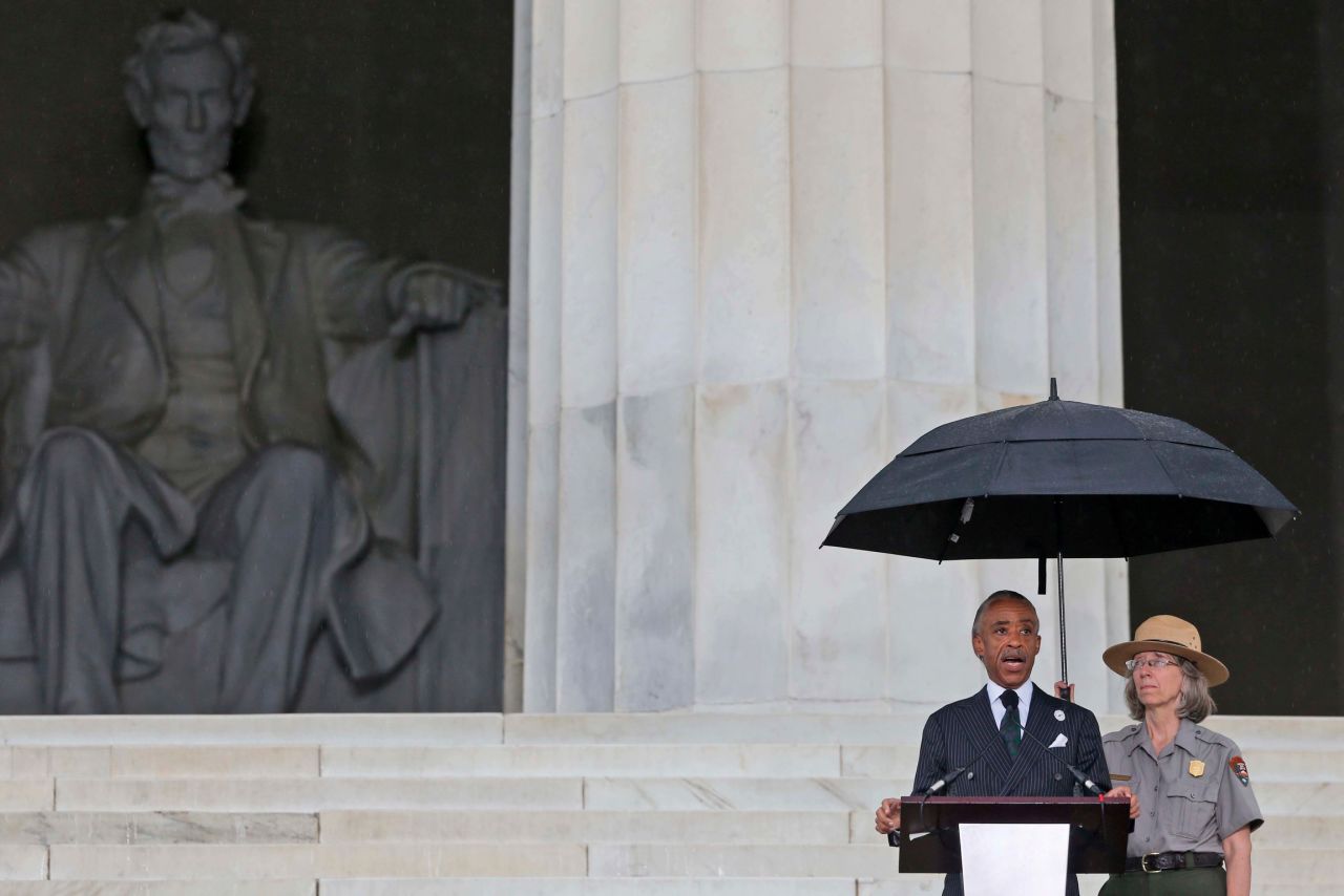 A light rain falls as the Rev. Al Sharpton addresses the crowd.