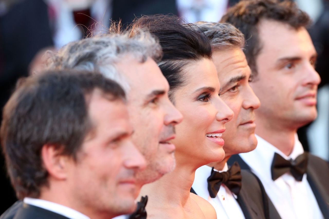 The cast and crew of "Gravity," from left, producer David Heyman, director Alfonso Cuaron, actress Sandra Bullock, actor George Clooney and screenwriter Jonas Cuaron, celebrate the movie's premiere Wednesday, August 28.