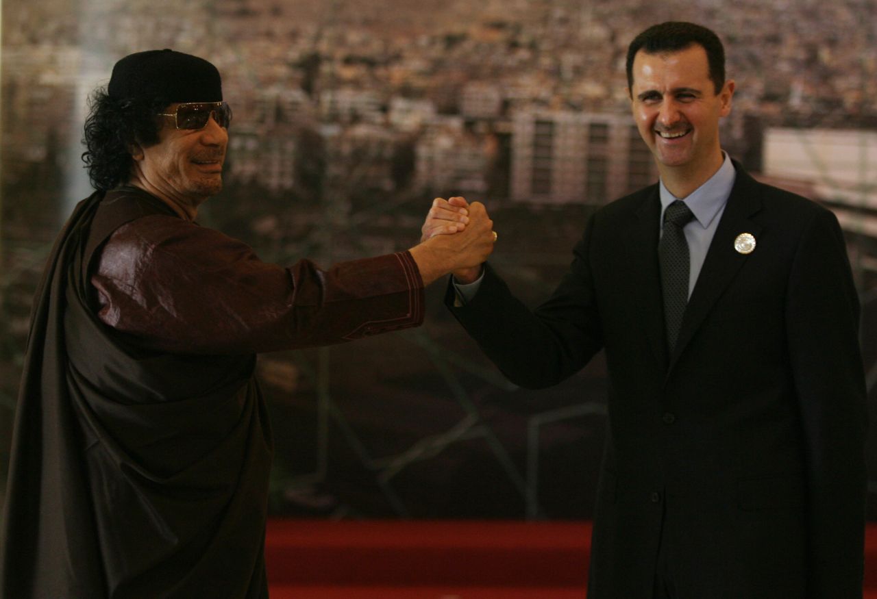 Moammar Gadhafi and al-Assad clasp hands at the opening session of the Arab Summit in Damascus on March 29, 2008.