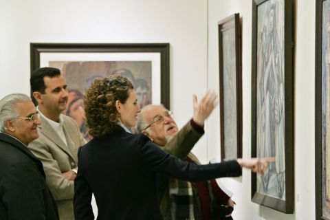 Bashar and Asma al-Assad listen to Syrian artist Elias al-Zayat during a visit to an exhibition at the national museum in Damascus on February 23, 2008.