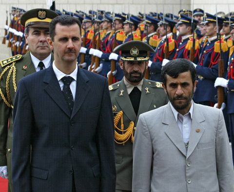Al-Assad and Iran's Mahmoud Ahmadinejad review the honor guard at Damascus airport on January 19, 2006. 