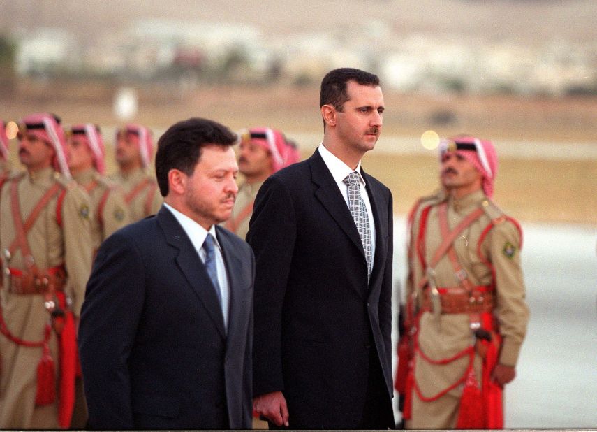 Jordanian King Abdullah ll and al-Assad inspect the honor guard on October 18, 2000, in Amman, Jordan.