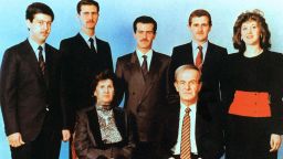 An undated  photo show's current Syrian President, second left, posing with his family.  Al-Assads parents, then-President Hafez al-Assad and his wife Anisseh, along with his siblings in the second row; Maher, Bassel, Majd and Bushra.