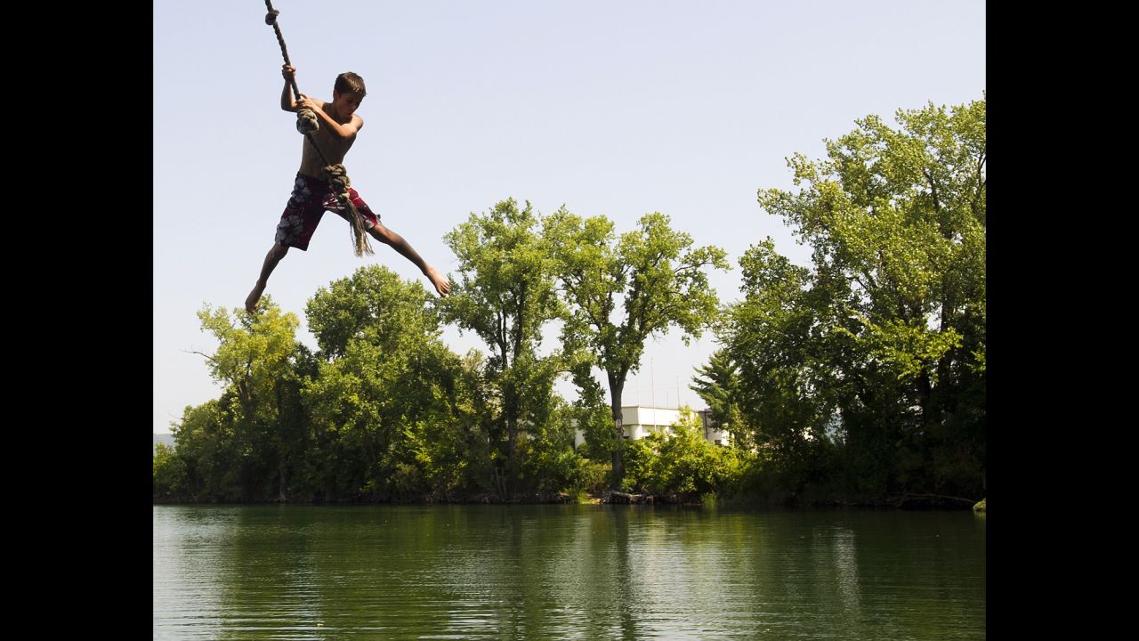 Reece Riebel, 13, prepares to take a plunge into Airport Lake in an effort to escape the heat in Winona, Minnesota, on August 26. 