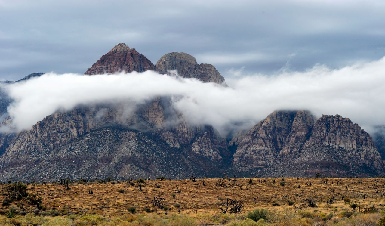 Clouds appear at the Red Rock Canyon National Conservation Area on August 26, near Las Vegas, Nevada. Moisture from Tropical Depression Ivo has caused heavy rains and flooding in parts of the Las Vegas Valley.  