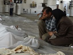 A Syrian man mourns over the bodies of those killed in an alleged chemical weapons attack in Damascus, Syria, in 2013.