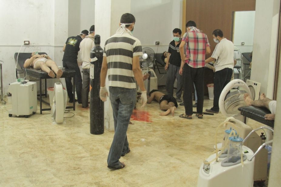 People attend to the victims of the attack on August 21 in Damascus. British intelligence said at least 350 people died, while rebel leaders have put the death toll at more than 1,300. 