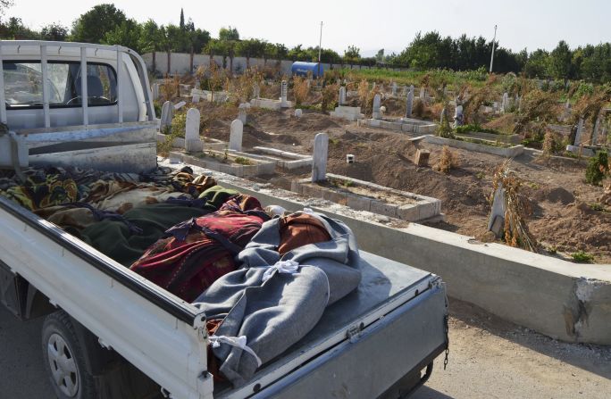 Victims of the attack are laid in the back of a truck in the Hamoria area of Damascus on August 21.