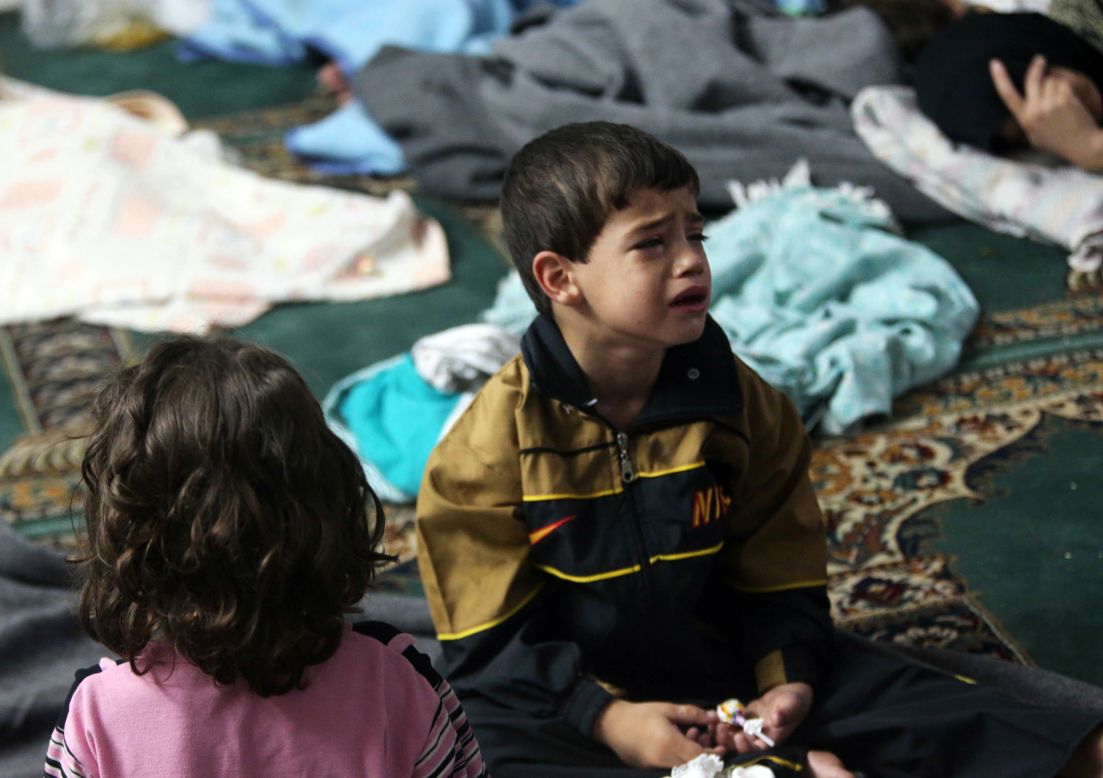 A young survivor takes shelter in a mosque in the Duma neighborhood of Damascus on August 21. 