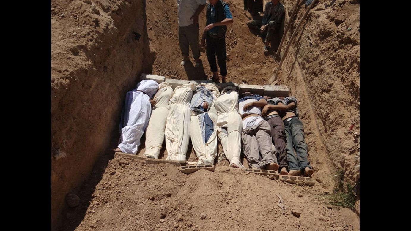 Victims are buried in a suburb of Damascus on August 21. 