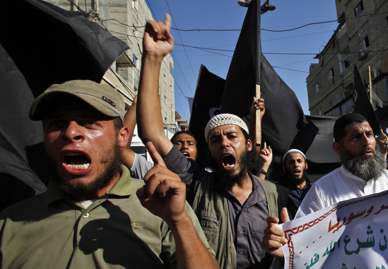 A group of young Salafists chants and waves black flags during a protest against the Egyptian and Syria regimes in the southern Gaza Strip on August 22. 