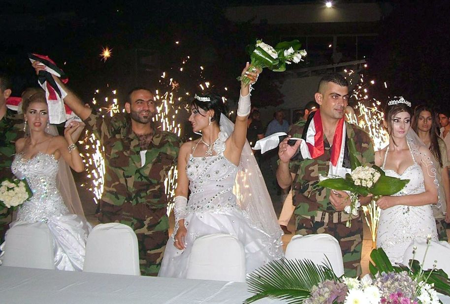 Syrian soldiers celebrate with their their brides during a group wedding in Latakia province.