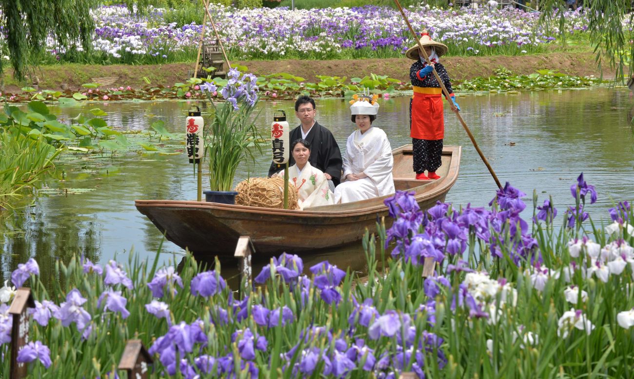 A Japanese bride and her groom sail through a canal for their wedding procession after their wedding ceremony at Katori city in Chiba prefecture.