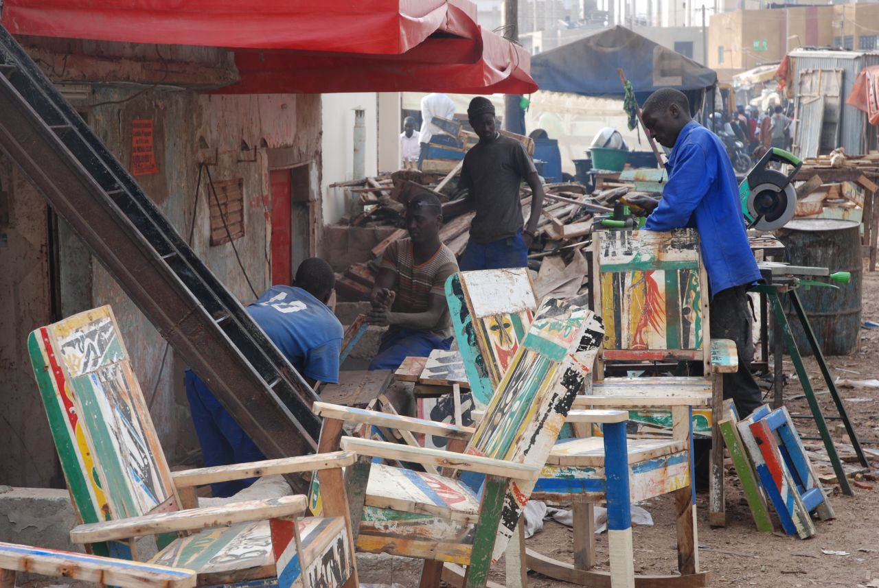 The company's workshop in Dakar, Senegal's capital, has 12 young craftsmen who undertake the arduous task of re-modeling the samba wood.