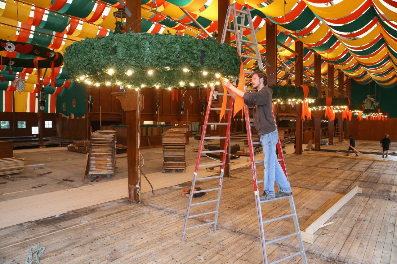 A worker decorates chandliers at the Schuetzen Festzelt three weeks ahead of Oktoberfest.