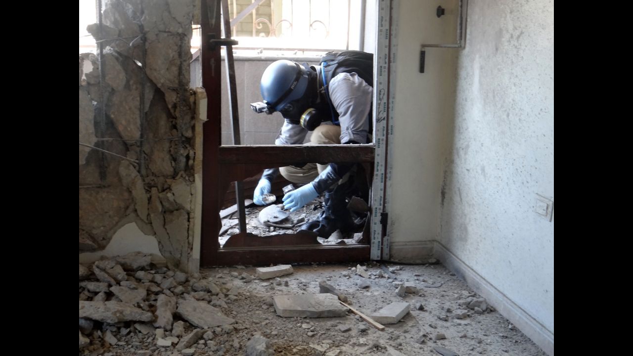 A U.N. arms expert collects samples during an inspection of a suspected chemical weapons strike site in the Ghouta area outside Damascus on August 29.