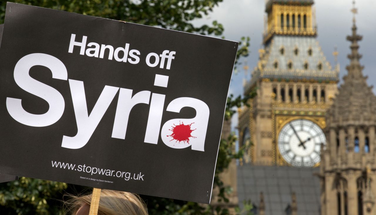 Demonstrators protest against military involvement in Syria outside the Houses of Parliament in London on Thursday, August 29. British Prime Minister David Cameron failed to secure Parliament's approval for military intervention in Syria. Western powers have debated the use of military force against Syria's government in response to a chemical weapons attack outside Damascus.
