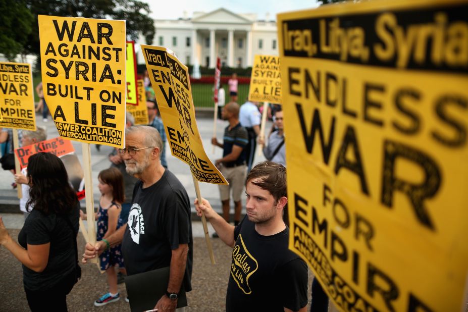 Demonstrators, including former CIA analyst Ray McGovern, second from left, gather on the north side of the White House to protest possible U.S. military action against Syria on August 29.
