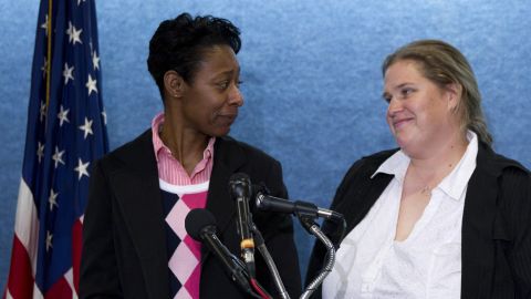 Tracey Cooper-Harris, who served in the Army for 12 years, left, and  her spouse, Maggie Cooper-Harris speak during a news conference in Washington, Feb. 1, 2012. 
