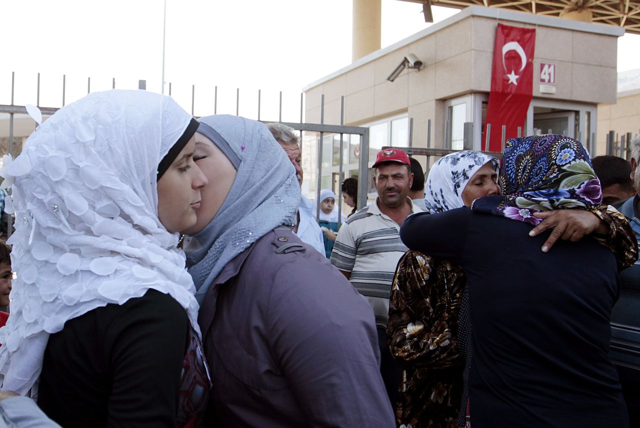 AUGUST 30 - CILVEGOZU, TURKEY: <a href="http://cnn.com/2013/08/28/world/meast/syria-how-did-we-get-here/index.html">Syrian refugees</a> greet each other at the Turkish Cilvegozu gate border with Syria. The crisis in Syria has escalated this week, with United Nations experts investigating the alleged use of <a href="http://cnn.com/2013/08/28/world/meast/syria-how-did-we-get-here/index.html?hpt=hp_t2">chemical weapons</a>. The U.S. and allies are preparing for the <a href="http://cnn.com/2013/08/30/world/europe/syria-civil-war/index.html?hpt=hp_t1">possibility of a punitive strike</a> against President Bashar al-Assad's regime.