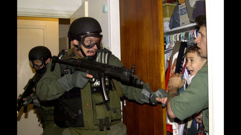 During a raid at a Miami home in 2000, armed federal agents confront Elian Gonzalez, 6, and one of the men who helped rescue the boy. Gonzalez watched his mother drown when the boat smuggling them from Cuba capsized. Under international law, U.S. authorities were required to return the boy to his father in Cuba. Alan Diaz's photograph of the saga's defining moment won a Pulitzer Prize. "The cry I heard that day I had never heard in my life," <a href="index.php?page=&url=http%3A%2F%2Farticles.sun-sentinel.com%2F2010-04-22%2Fnews%2Ffl-elian-photographer-20100422_1_cry-elian-gonzalez-haunted" target="_blank" target="_blank">Diaz said a decade later</a>. "A cry like that will haunt anyone forever."