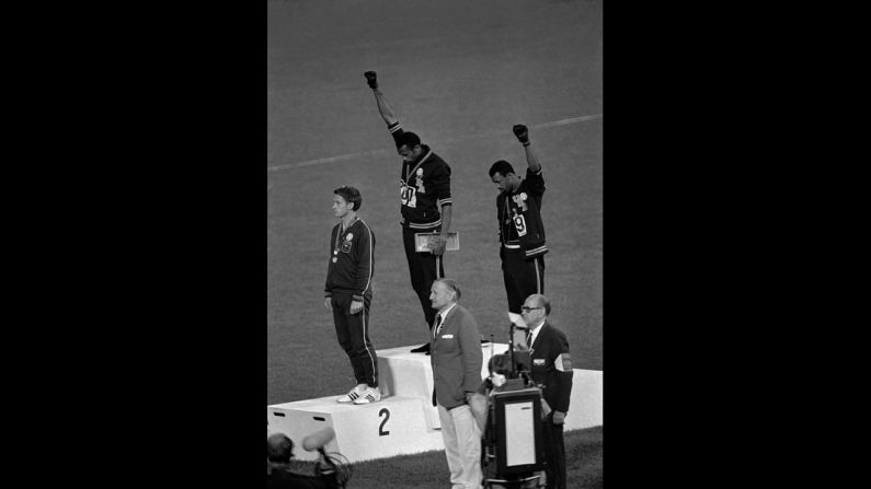 American athletes Tommie Smith, center, and John Carlos raise their fists and hang their heads while the U.S. national anthem plays during their medal ceremony at the 1968 Summer Olympics in Mexico City. Their black power salute became front page news around the world as a symbol of the struggle for civil rights. To their left stood Australian Peter Norman, who <a href="index.php?page=&url=http%3A%2F%2Fwww.cnn.com%2F2012%2F08%2F21%2Fworld%2Fasia%2Faustralia-norman-olympic-apology%2Findex.html">expressed his support</a> by wearing an Olympic Project for Human Rights badge.