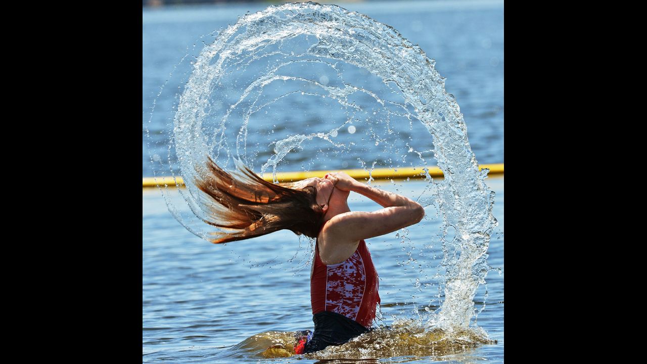 Kayla Paxton whips her head out of the water during a splashing contest with her brother in Creedmoor, North Carolina, on August 26.