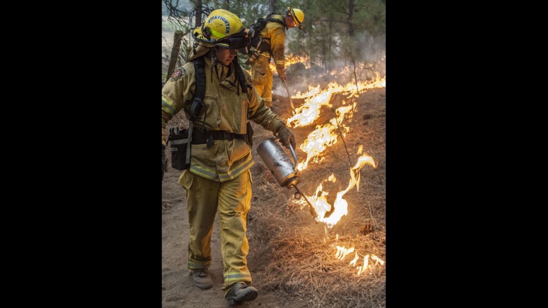 Firefighters from Sacramento Metro burn around an old cabin in Ackerson Meadow near Yosemite National Park on August 28.