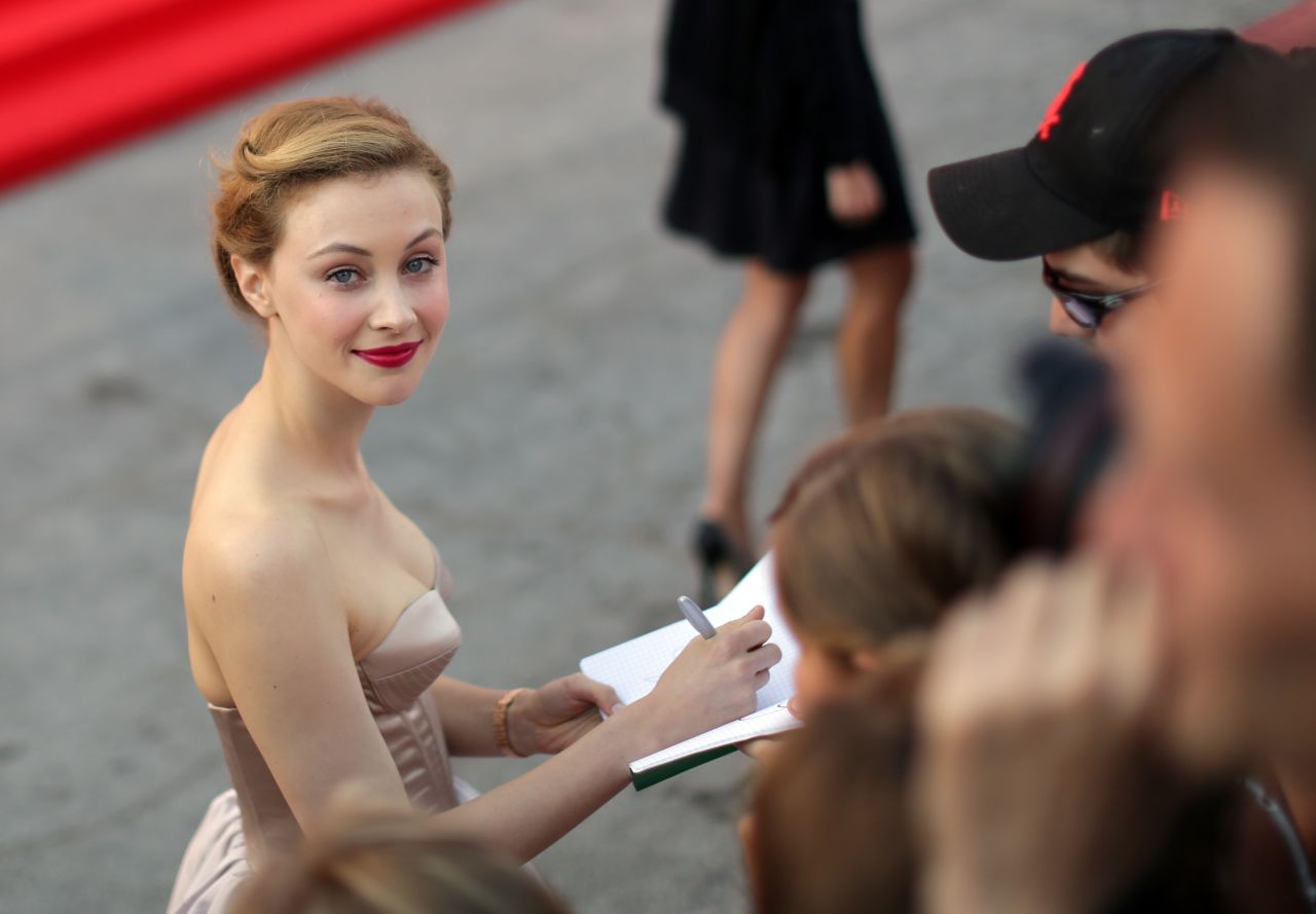 Actress Sarah Gadon signs autographs as she arrives for the screening of the film "Joe" on Friday, August 30.