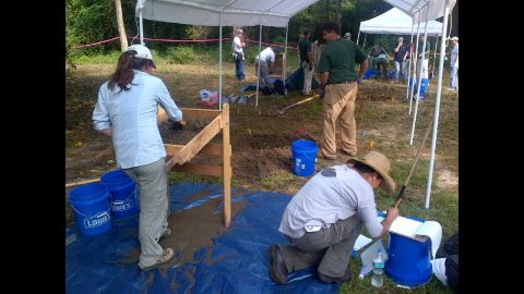 The team excavates and examines the bodies. 