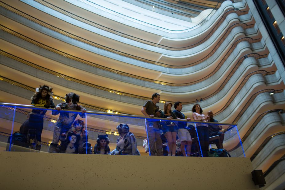 Onlookers watch the crowds that fill the lobby of the Marriott Marquis late Friday night. 