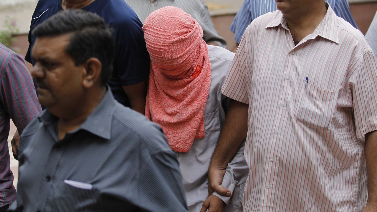 Delhi police officers escort a juvenile accused of rape, outside the Juvenile justice board in New Delhi, India, Saturday, Aug. 31, 2013. An Indian juvenile court on Saturday handed down the first conviction in the fatal gang rape of a young woman on a moving New Delhi bus, convicting the teenager of rape and murder and sentencing him to three years in a reform home, lawyers said. (AP Photo/Altaf Qadri)