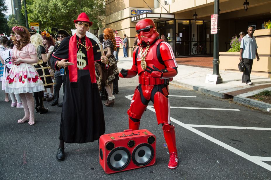 People dressed as the Pimp Priest and the Hip-Hop Stormtrooper attend the parade.