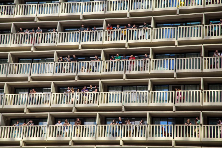 People watch the parade from balconies at the Hyatt Regency.