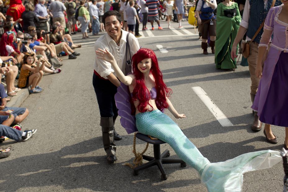 Ariel, "The Little Mermaid," gets a little dry-land help moving along the parade route.