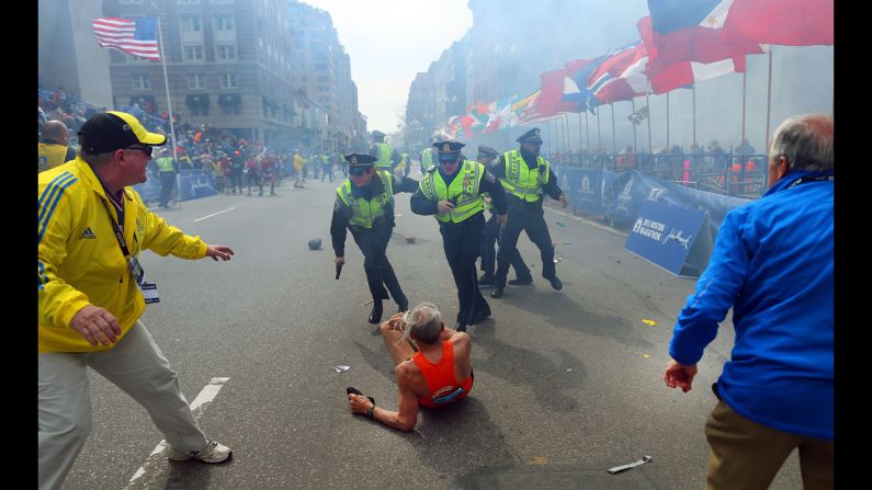 Boston Globe photographer John Tlumacki was near the finish line when 78-year-old runner <a href="index.php?page=&url=http%3A%2F%2Fpiersmorgan.blogs.cnn.com%2F2013%2F04%2F15%2Fbill-iffrig-subject-of-iconic-boston-globe-photo-the-shock-waves-hit-my-whole-body-my-legs-just-started-jittering-around-i-knew-i-was-going-down%2F">Bill Iffrig was knocked down</a> by the first explosion at the Boston Marathon on April 15. The bombings left three people dead and injured more than 100. Iffrig got up and finished the race. Tlumacki's image of the fallen runner was widely published and selected for the cover of "Sports Illustrated."