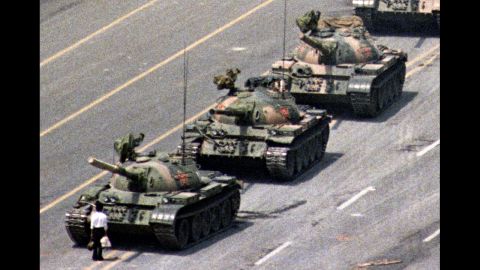 Following a crackdown that resulted in the deaths of hundreds of student demonstrators in Beijing, a lone Chinese protester steps in front of People's Liberation Army tanks in Tiananmen Squarein 1989. At least five photographers captured the event, which became a symbol of defiance in the face of oppression. Charlie Cole, working for Newsweek, won a World Press Photo Award for his version of the image. The identity and fate of the "Tank Man" remains unclear.