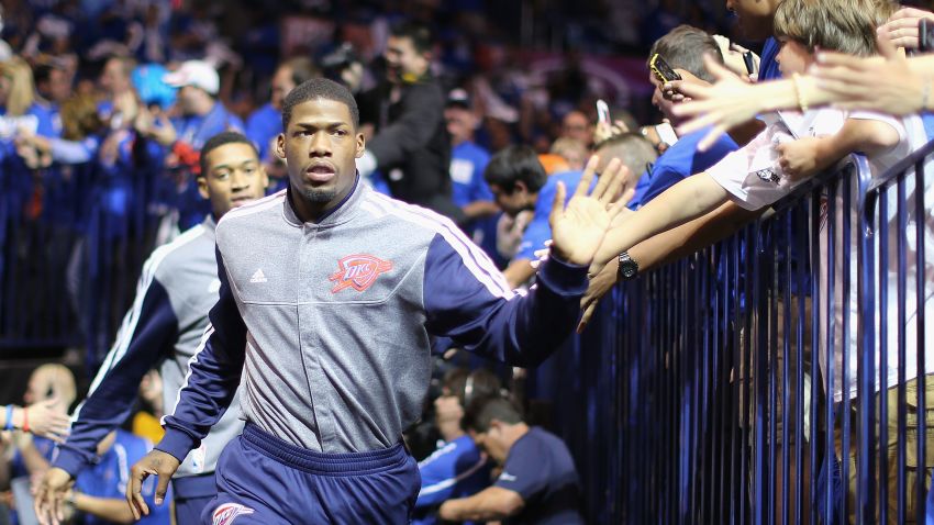 DeAndre Liggins of the Oklahoma City Thunder high-fives fans as he runs out onto the court before Game One of the Western Conference Quarterfinals of the 2013 NBA Playoffs against the Houston Rockets at Chesapeake Energy Arena on April 21, 2013 in Oklahoma City, Oklahoma.