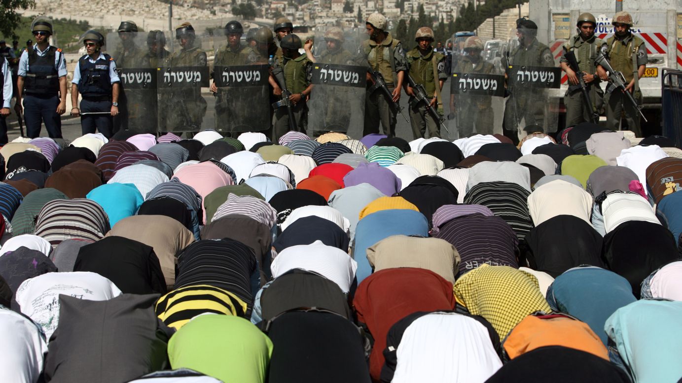 Israeli police stand guard as Palestinian Muslims perform Friday prayers outside Jerusalem's Old City. Palestinians are mostly Arab and chiefly Muslim, but there are substantial minorities of Palestinian Christians and others.