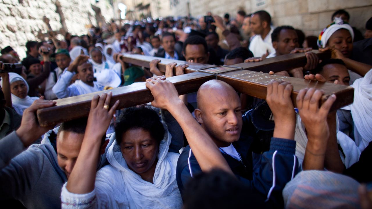Christian pilgrims hold a wooden cross as they take part in the Good Friday procession along the Via Dolorosa. The Via Dolorosa leads to the Church of the Holy Sepulchre, where Christian tradition says Jesus was crucified and buried.