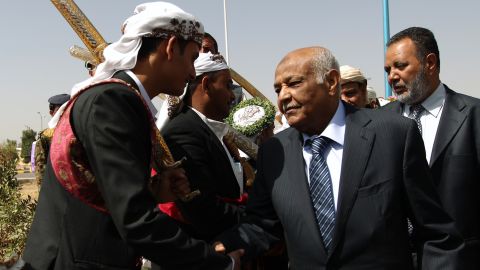 Yemeni PM Mohammed Salem Basindwa (R) at a mass wedding ceremony in Sanaa on March 14, 2013. 